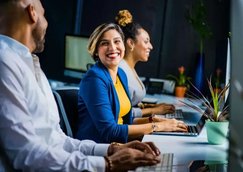 Confident partner smiling among colleagues